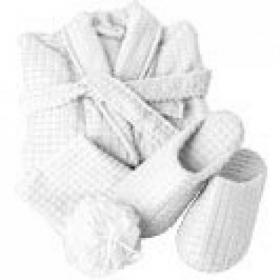 Polyester wellness set with waffle design bathrobe with two front pockets, a wash cloth (approx. 30 x 31 cm) pair of slippers with small anti-slip silicon dots, all folded together and tied with a matching ribbon.